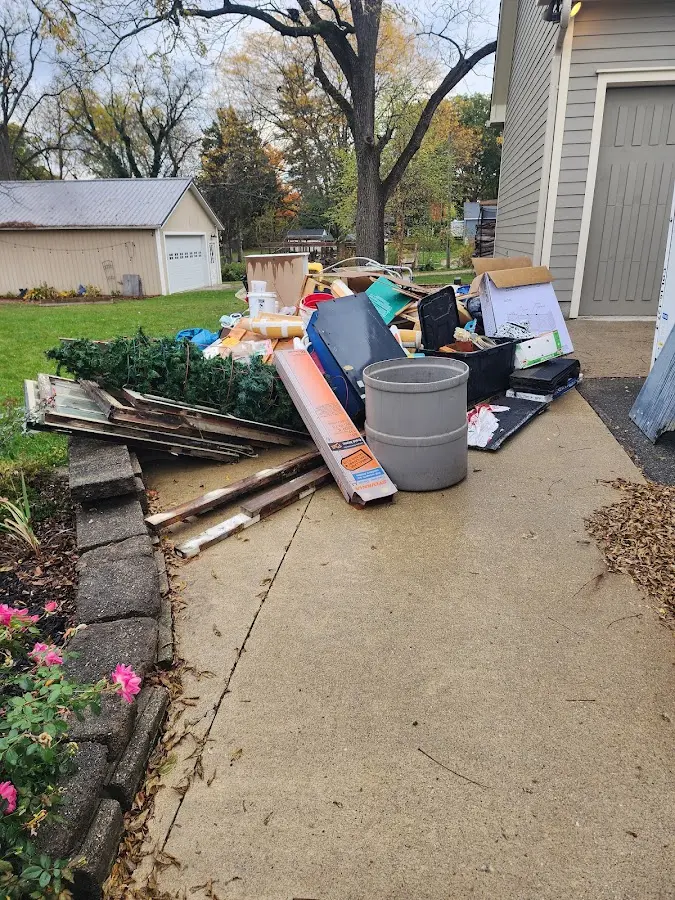 Dumpster being loaded with debris for Estate Cleanout Dumpster Rental in Country Club Hills